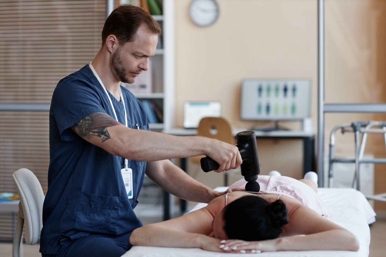 Massage therapist using massager for procedure
